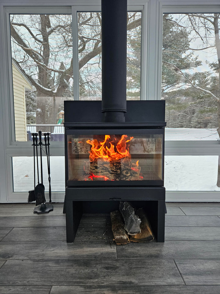 Front photo of the KFD Ariana with stand in a beautiful sunroon in wisconsin- Multi Sided See through Direct Vent or Wood Burning Fireplace