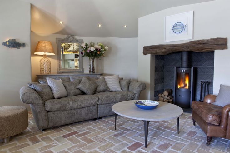 Living room with a fireplace, sofa, and coffee table. Alcove Stove Round modern rotating wood stove
360 degree fireplace
eco-friendly wood stove
high efficiency fireplace
clean burning wood stove
European design fireplace
contemporary wood-burning stove
STUV 30 fireplace wood stove dealer Modern fireplaces in Bend Oregon Central and Southern Oregon Eastern Oregon Idaho Washington Northern California Nevada Utah luxury fireplace design
statement fireplace for living room
energy efficient heating solutions
d