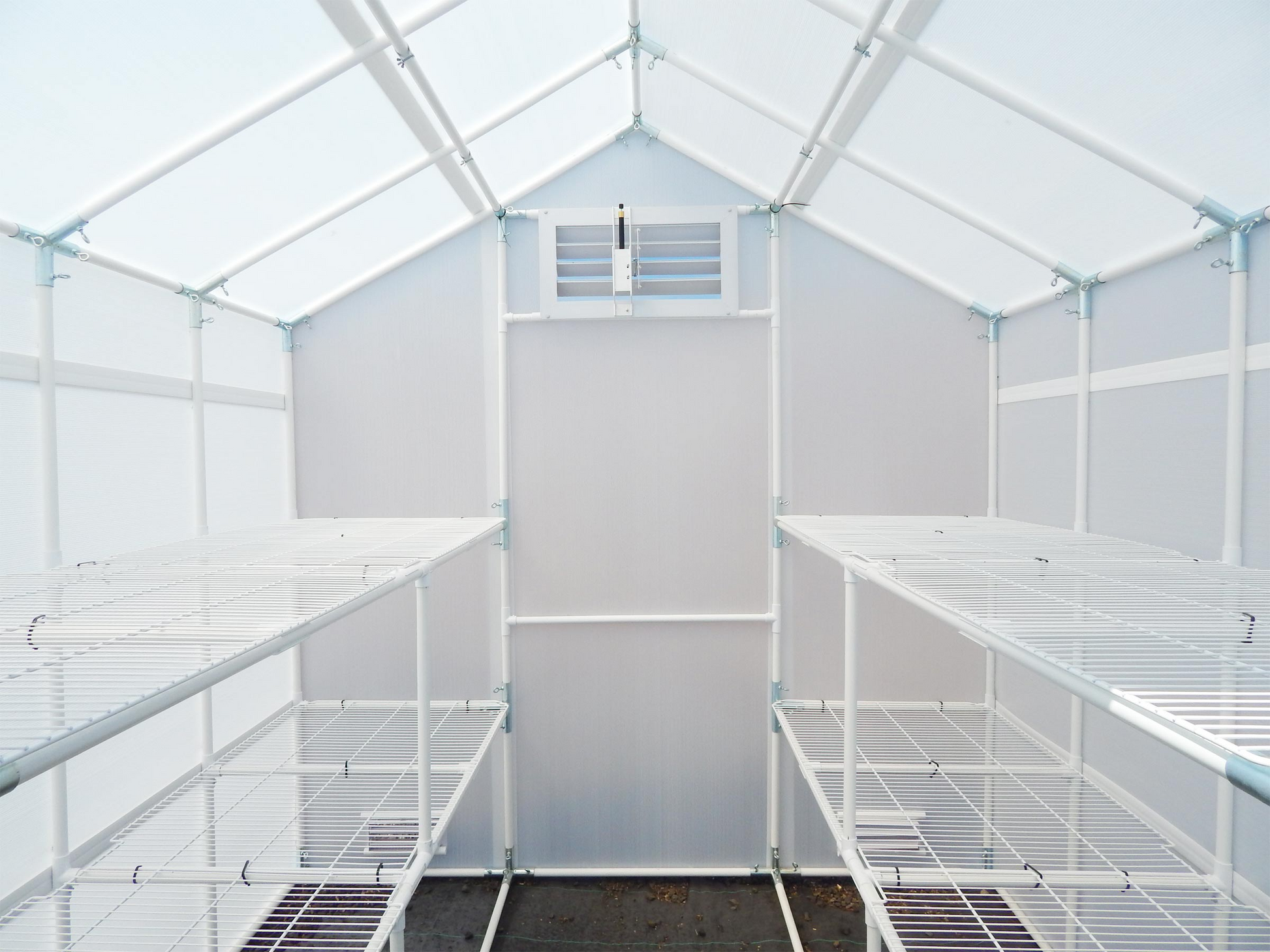 Inside of a garden Master Small Greenhouse with a four bench frame and automatic Open Louver
