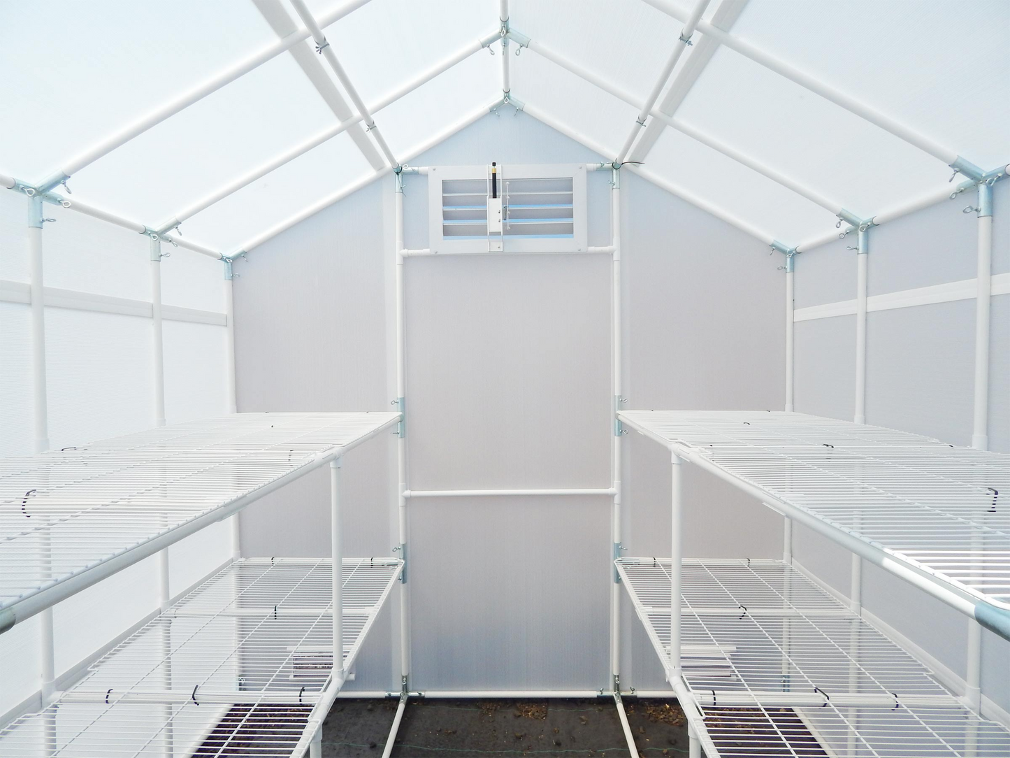 Inside view of 8' X 16' solexx garden master outdoor greenhouse showing four bench frame and auto open louver
