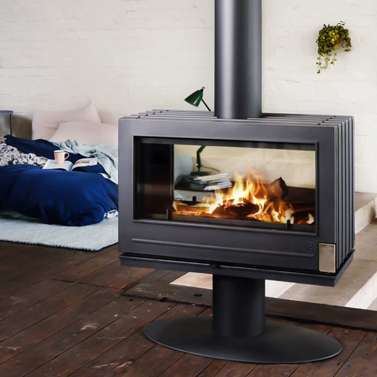 Middle of the living room double glass pedestal cast iron wood stove cozy master bedroom Modern Fireplace. Also knows as a midcentury modern fireplace this brand new stylish.