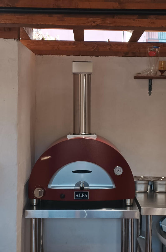 This is Our Customers Photo of our Alfa 2 Pizze Hybrid Pizza Oven in their outdoor kitchen- look closely you can see the beer boot on the shelf- Alfa is made for entertaining Outdoor Wood Pizza cooking with Italian Flair. This the Alfa Ciao on top the the large prep table. The True Italian pizza oven the Alfa Forno Ciao is a wood fired pizza oven for the backyard pizza enthusiast. This pizza oven you can add the cart, legs or just use your own backyard table. LOW AND SLOW KIT AVAILABLE 