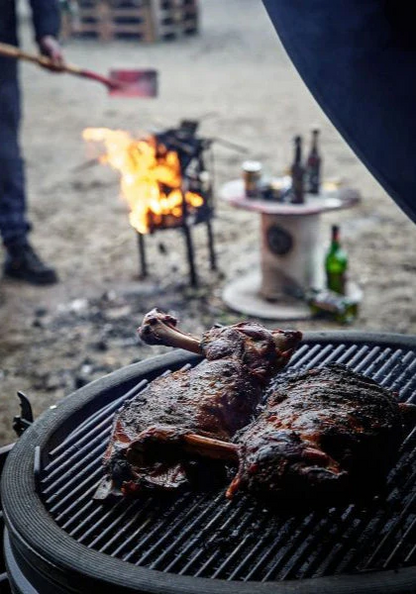 Outdoor cooking using 54" height black BSTRD urban large solo Kamado Grill