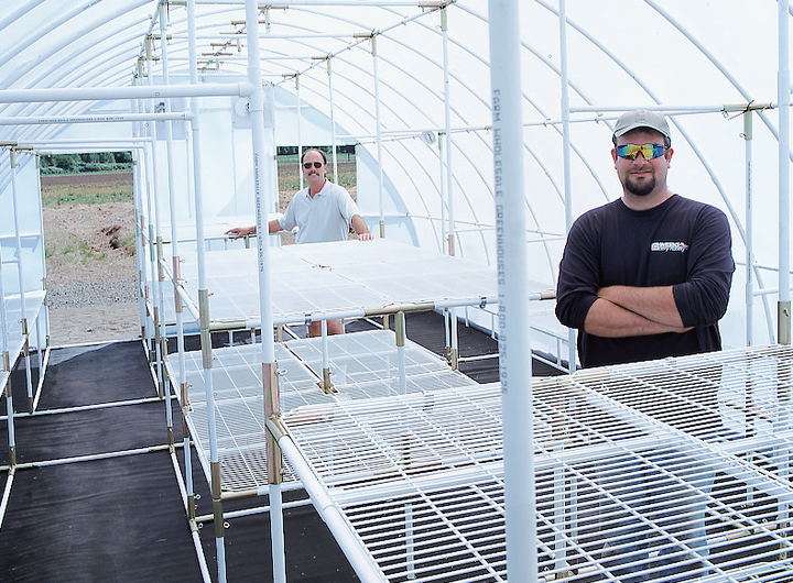 Two men standing in the middle of spacious 9'6" conservatory outdoor greenhouse