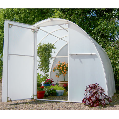 Exterior view of 8' X 8' Early Bloomer greenhouse kit showing flower and plants arranged inside the outdoor greenhouse