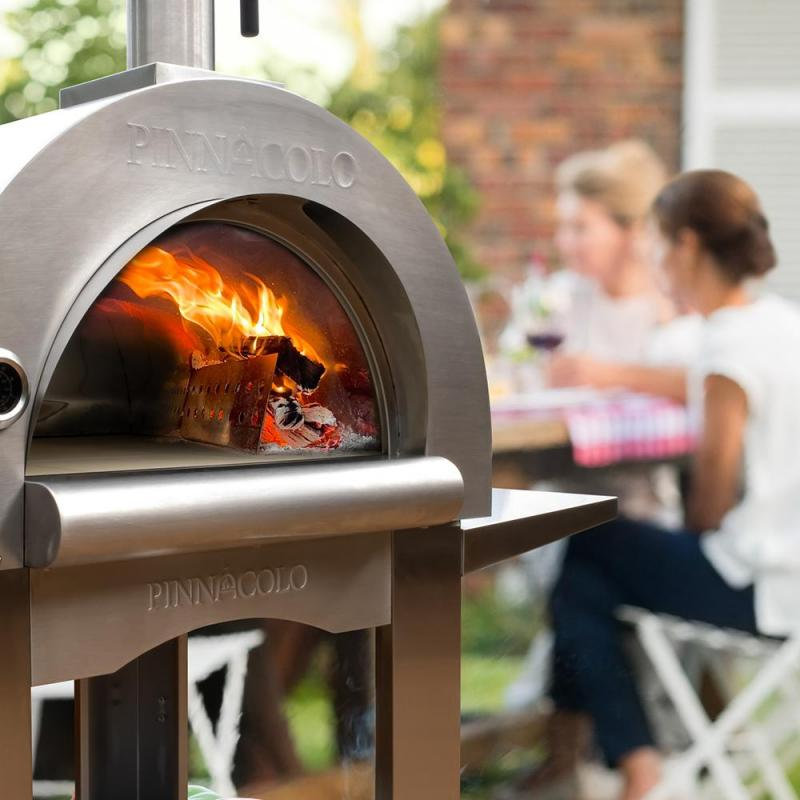 Pinnacolo Premio Wood-fired oven with people sitting at a table in the background