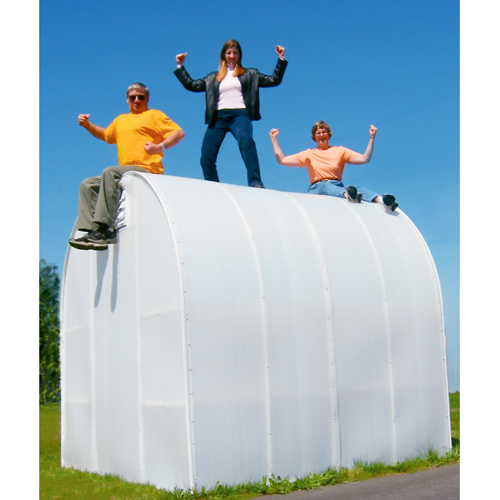 Two women and a man are sitting down on top of the 8' X 8' Solexx gardeners Oasis Outdoor greenhouse