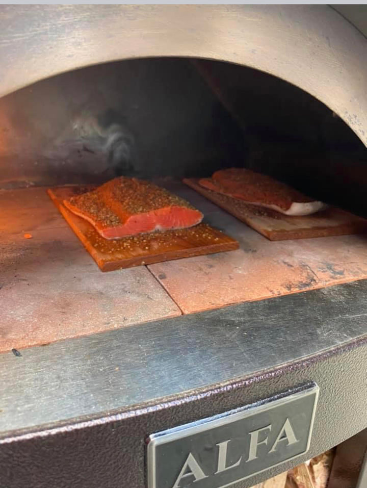Cook Some Salmon on your back porch while getting the flavor from wood burning Pizza Oven