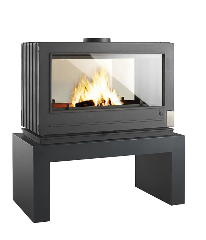 Double sided glass fireplace with the short invicta handmade steel bench. Firewood storage while heating your cabin with a solid wood fireplace