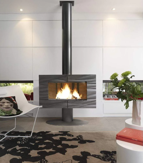 This mid century modern living room is capped off perfectly by the Invicta Wood fireplace made in France and designed with the best technology for keeping the glass clean and the heat output high